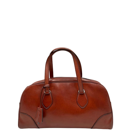 front Borsa Prada in pelle color terracotta con parti metalliche argentate; munita di doppi manici. Completa di dustbag, lucchetto e chiavi, di lusso, originale, ottime condizioni.