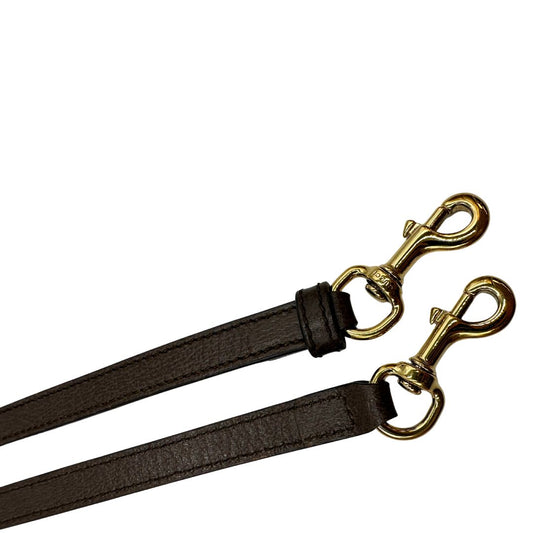 Tracolla Gucci regolabile in pelle testa di moro con parti metalliche dorate.