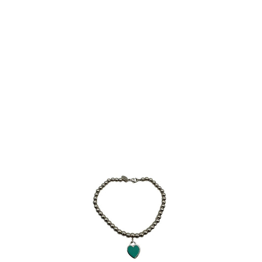 Bracciale Tiffany&Co. della collezione Return to Tiffany in argento 925 composto da sfere circolari e ciondolo cuore smaltato in verde Tiffany. Completo di scatola e sacchetto anti polvere.