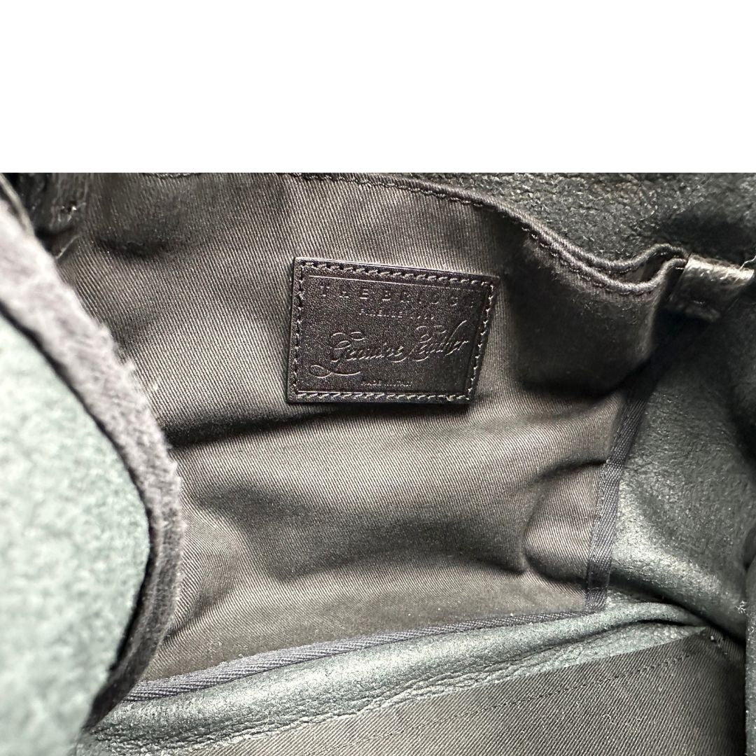 Interno Zaino The Bridge in pelle martellata nera, rifinito con parti metalliche dorate, munito di bretelle in pelle regolabili. Completo di dustbag. Originale, usata, di lusso, in ottime condizioni