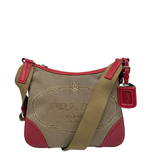 Front di una Borsa Prada in tessuto Jacquard Beige con finiture in pelle rossa e parti metalliche argentate; munita di una tracolla regolabile. Originale, usata, di lusso, in ottime condizioni