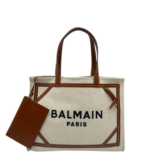 front Borsa Balmain in tessuto color sabbia rifinita con parti in pelle marroni; munita di doppi manici e una pochette estraibile