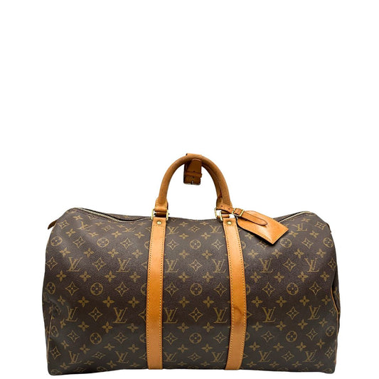 front Keepall 50 in canvas monogram marrone con finiture in vacchetta naturale e parti metalliche dorate; munito di doppi manici stondati, da portare a mano. Completo di lucchetto e chiavi, di lusso, originale, ottime condizioni, usata.