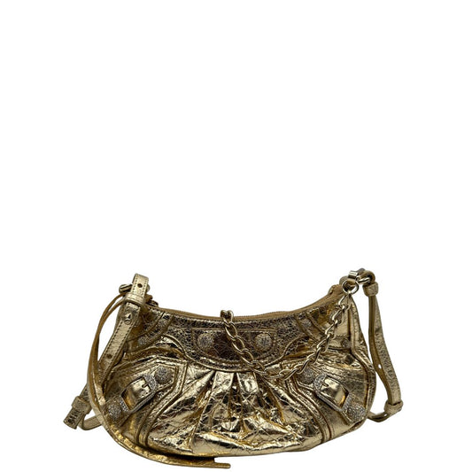 front Borsa Balenciaga in pelle dorata con parti metalliche dorate, impreziosita da borchie con cristalli incastonati; munita di un manico in catena e una tracolla regolabile. Completa di dustbag, di lusso, originale, ottime condizioni.