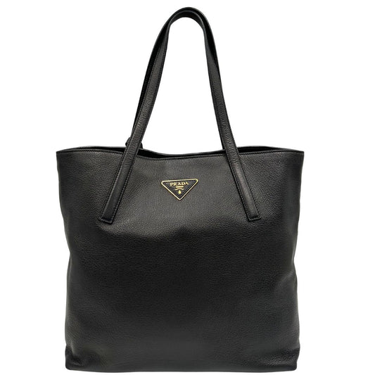 Front di una Borsa tote Prada in pelle martellata nera con parti metalliche dorate; munita di doppi manici. Indossabile a spalla. Originale, usata, di lusso, in ottime condizioni.
