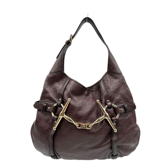 front Borsa Gucci in pelle GG color vinaccia con parti metalliche dorate; munita di un manico singolo e impreziosita da dettaglio Horsebit sul front. Completa di dustbag, di lusso, originale, ottime condizioni.