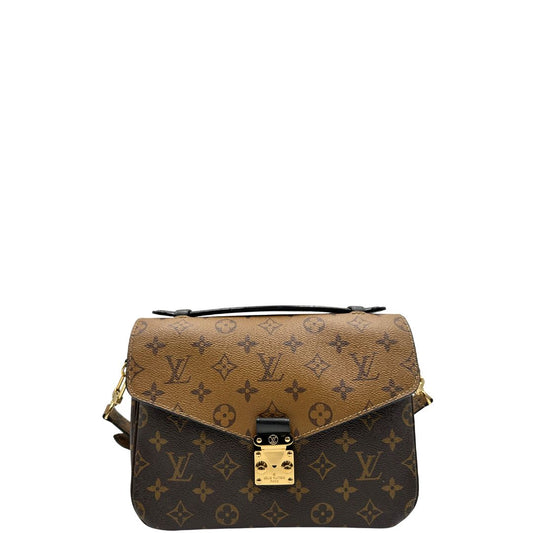 front Borsa Louis Vuitton Métis in canvas marrone monogram reverse con parti metalliche dorate; munita di un manico singolo e una tracolla amovibile e regolabile. Completa di scatola, di lusso, originale, ottime condizioni, usata.