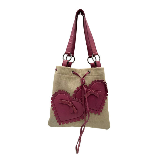 front Borsa Saint Laurent in tessuto beige con decorazioni a forma di cuori rosa in pelle; munita di doppi manici. Completa di dustbag, di lusso, originale, ottime condizioni, usata.