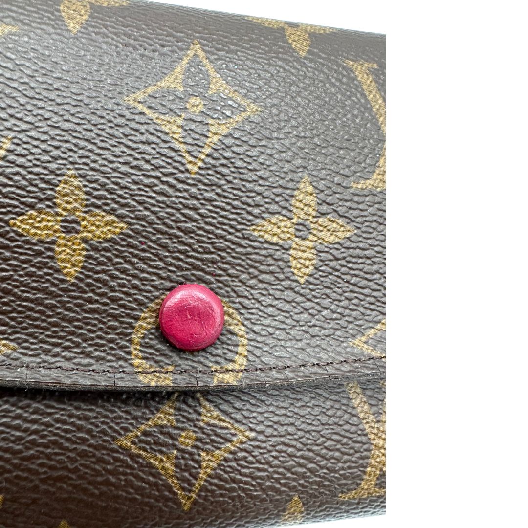 Chiusura di un Portafoglio Louis Vuitton Sarah in canvas monogrammato marrone e parti metalliche dorate con bottoncino amaranto. Completo di scatola. Originale, usata, di lusso, in ottime condizioni.