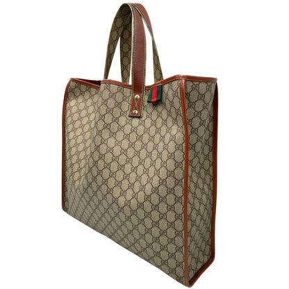 lato Tote Gucci in canvas GG beige con profili in pelle marrone e dettaglio Web verde e rosso, munita di doppi manici, indossabile a spalla, di lusso, originale, ottime condizioni. 