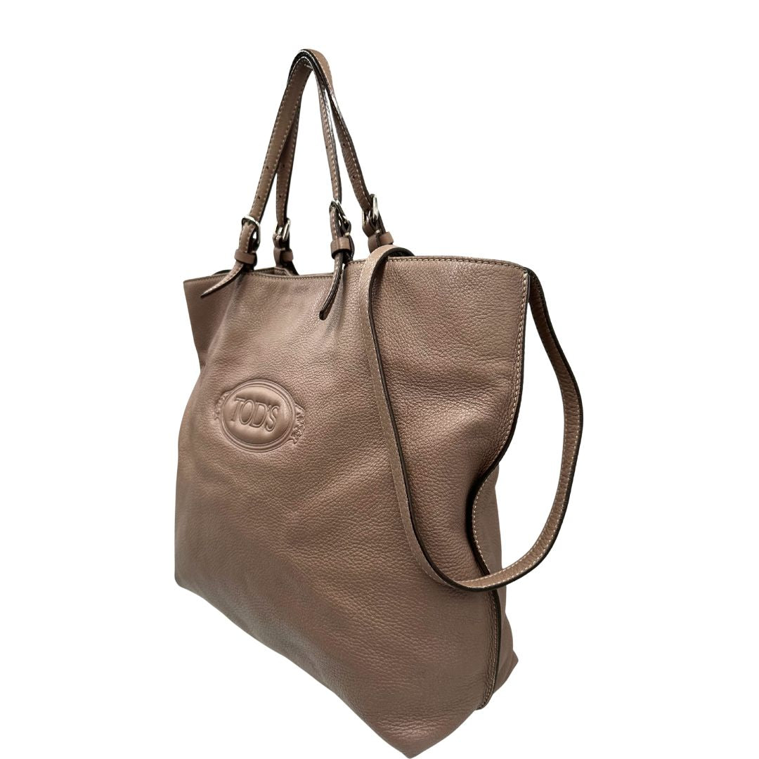 lato Borsa Tod's in pelle martellata color rosa cenere con parti metalliche argentate; munita di doppi manici e una tracolla regolabile. Completa di dustbag, di lusso, originale, ottime condizioni. 