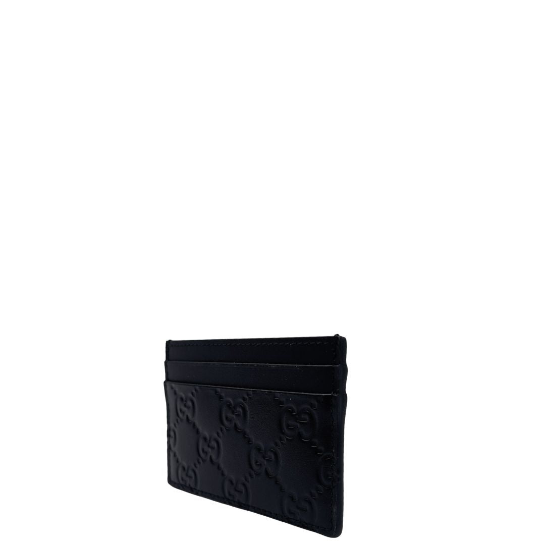 Portacarte Gucci GG in pelle nera trama Guccissima. 