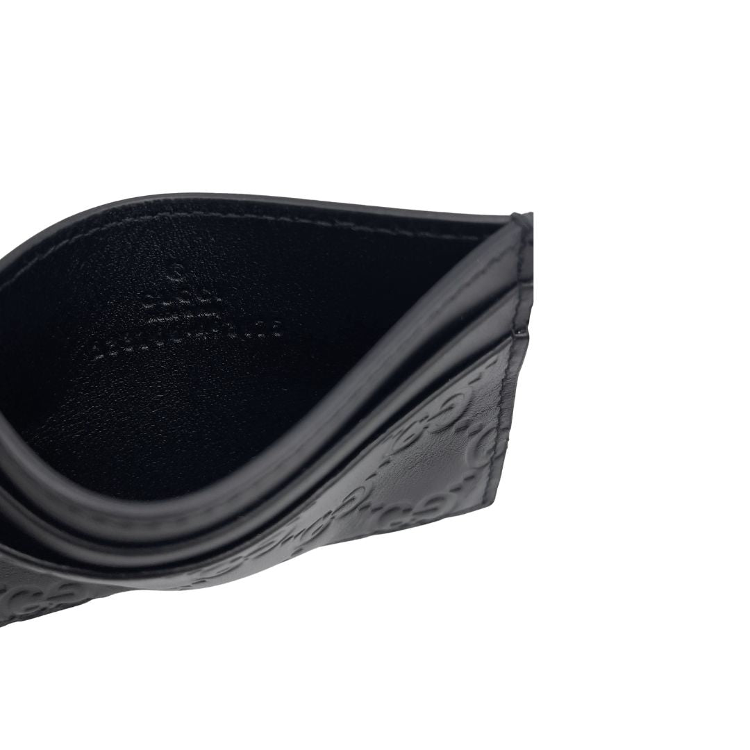 Portacarte Gucci GG in pelle nera trama Guccissima. 