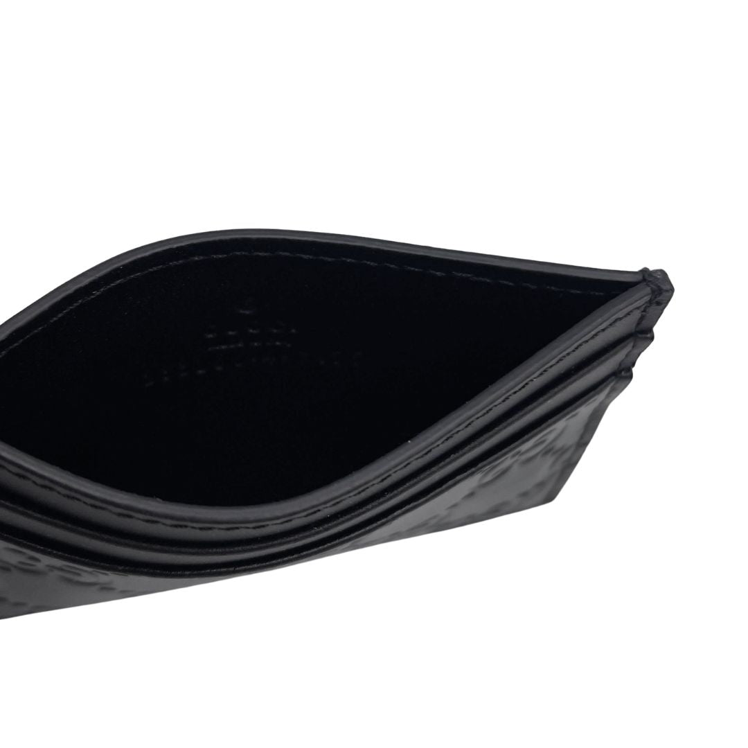 Portacarte Gucci GG in pelle nera trama Guccissima. 