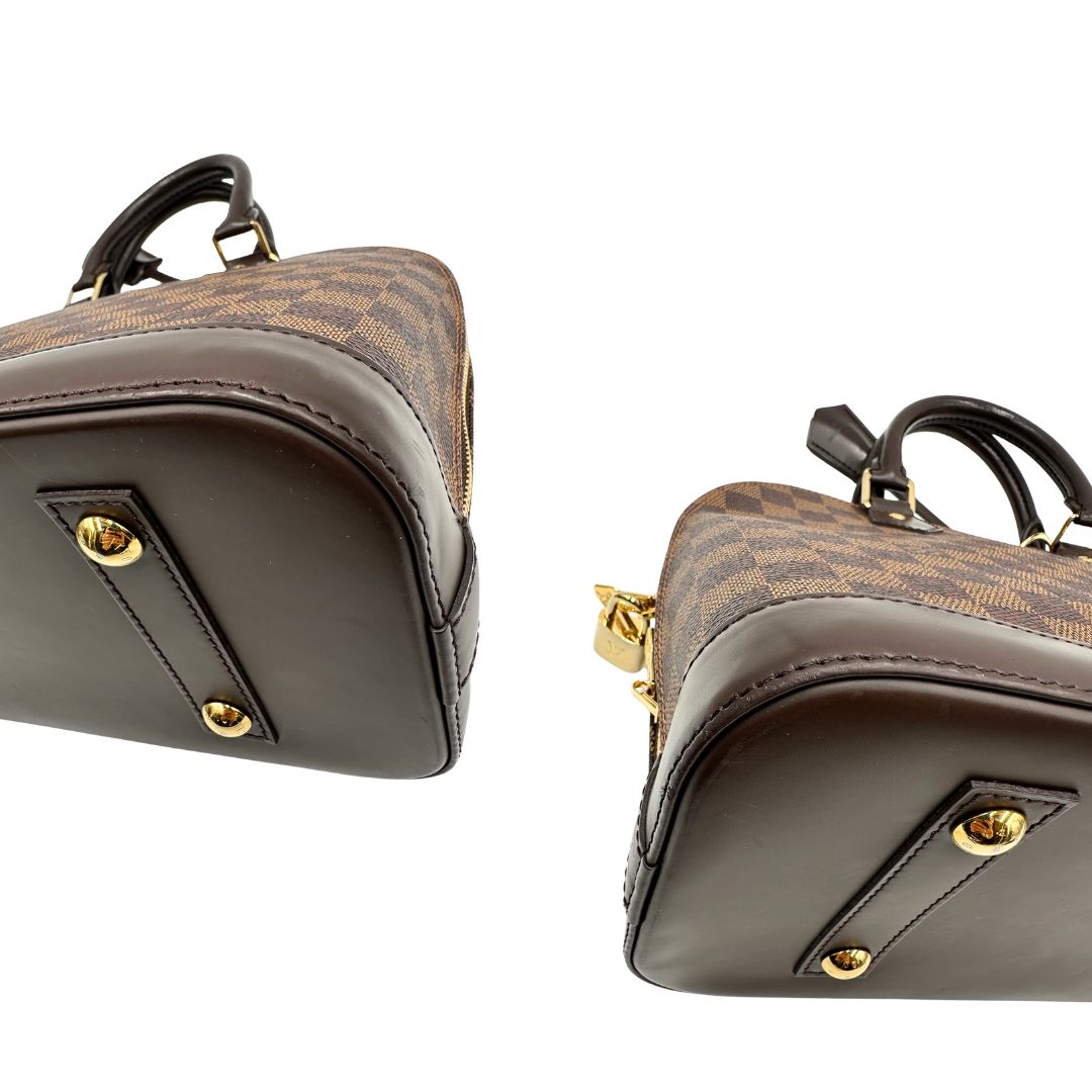 Angoli, Strutturata borsa Alma PM LV in canvas Damier Ébène e hardware dorato, indossabile a mano oppure a tracolla.