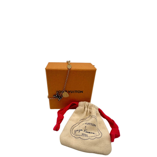 Bracciale LV Limited Edition in metallo dorato, con charm a forma di zucca e ciondolo logato LV a poi nero e bianco. Completo di corredo.