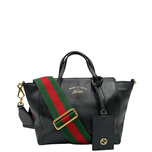 Gucci Swing Mini: elegante borsa in pelle nera con tracolla a righe rosse e verdi. Perfetta per un look sofisticato e pratico.