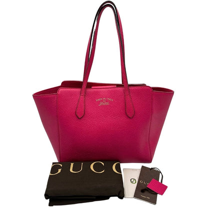 Borsa Gucci in pelle martellata fucsia rifinita con inserti metallici dorati; dotata di doppi manici, indossabile a spalla, dustbag 
