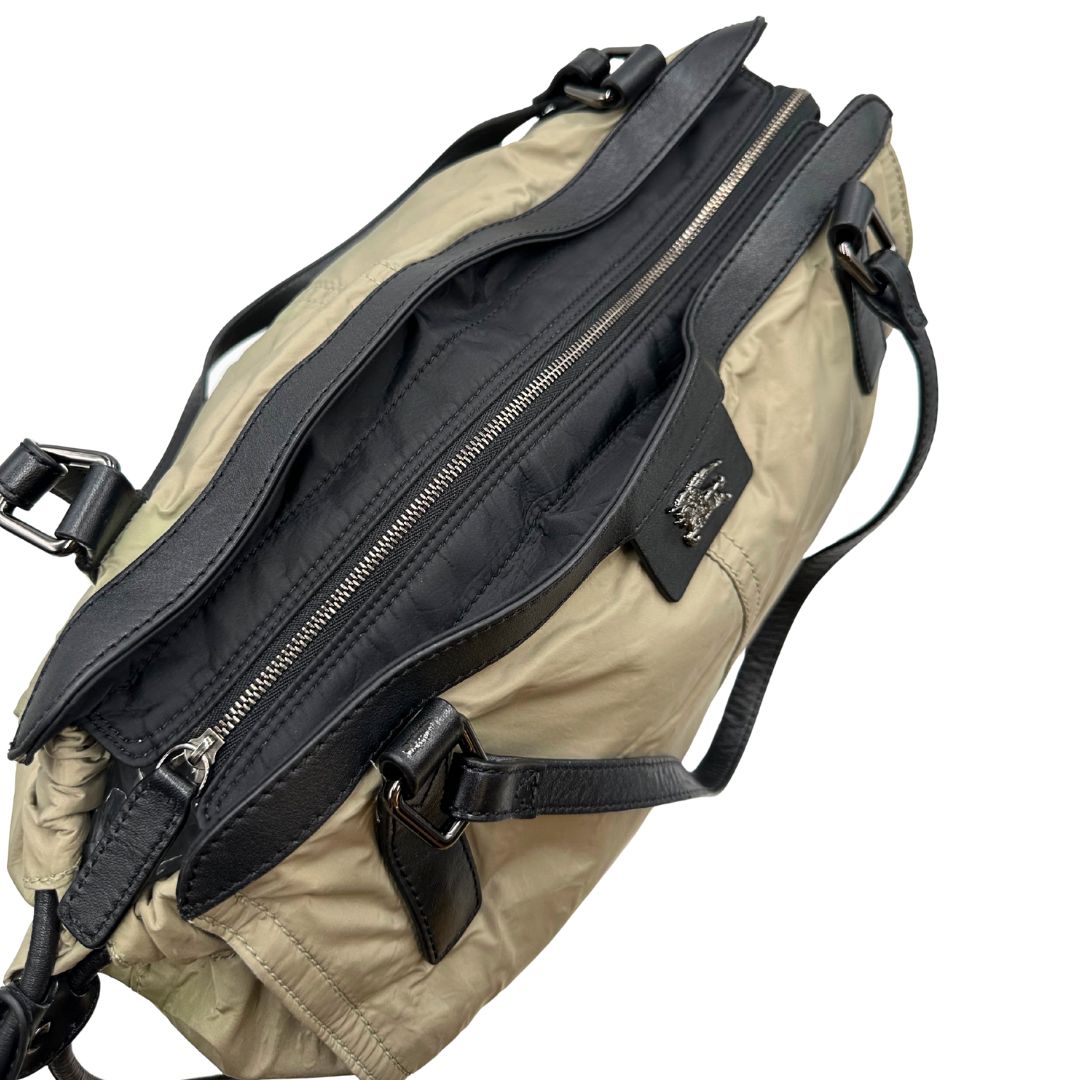 cerniera Borsa Burberry in nylon color sabbia rifinita con parti in pelle nere e inserti metallici effetto renio; munita di doppi manici, da indossare a spalla 