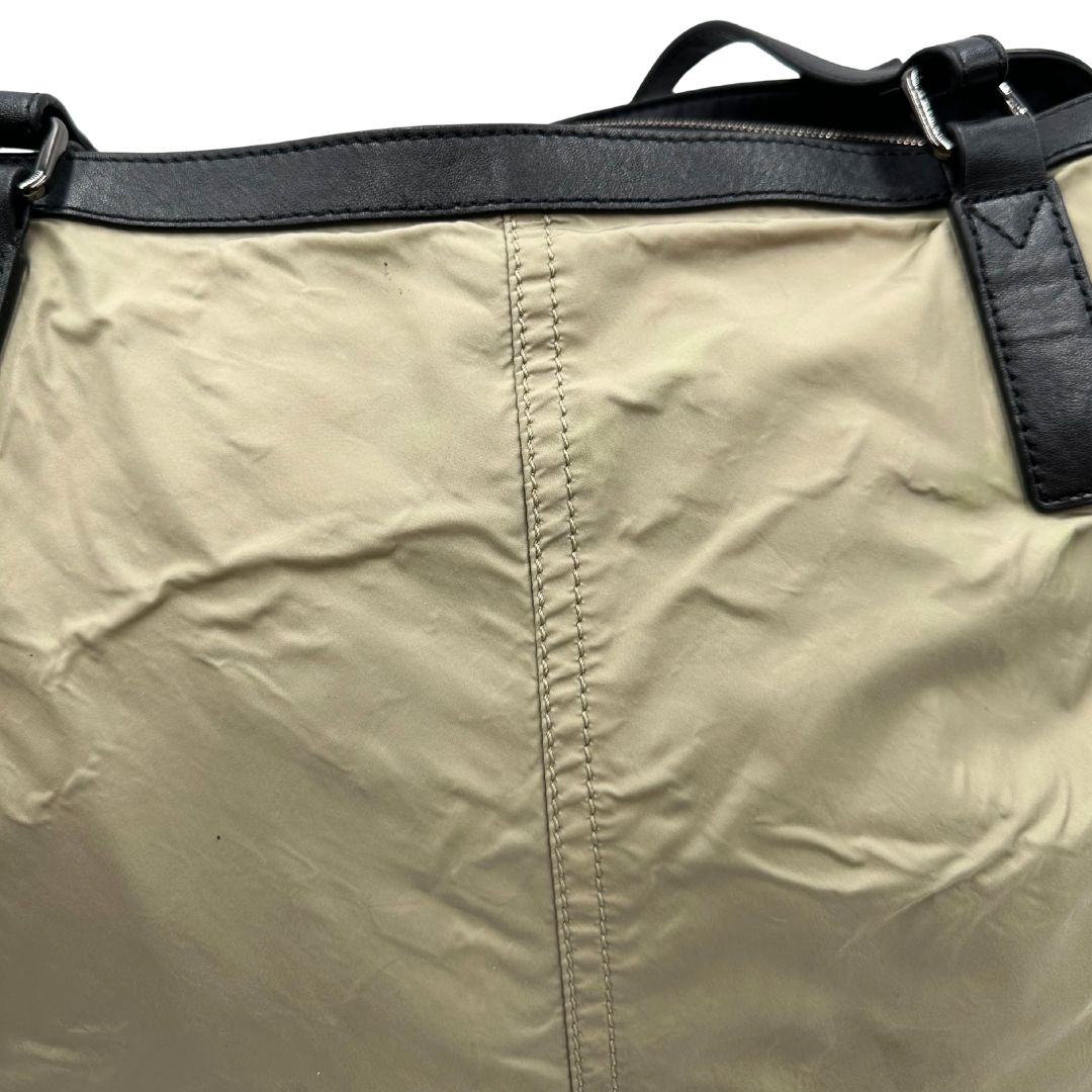 Borsa Burberry in nylon color sabbia rifinita con parti in pelle nere e inserti metallici effetto renio; munita di doppi manici, da indossare a spalla 