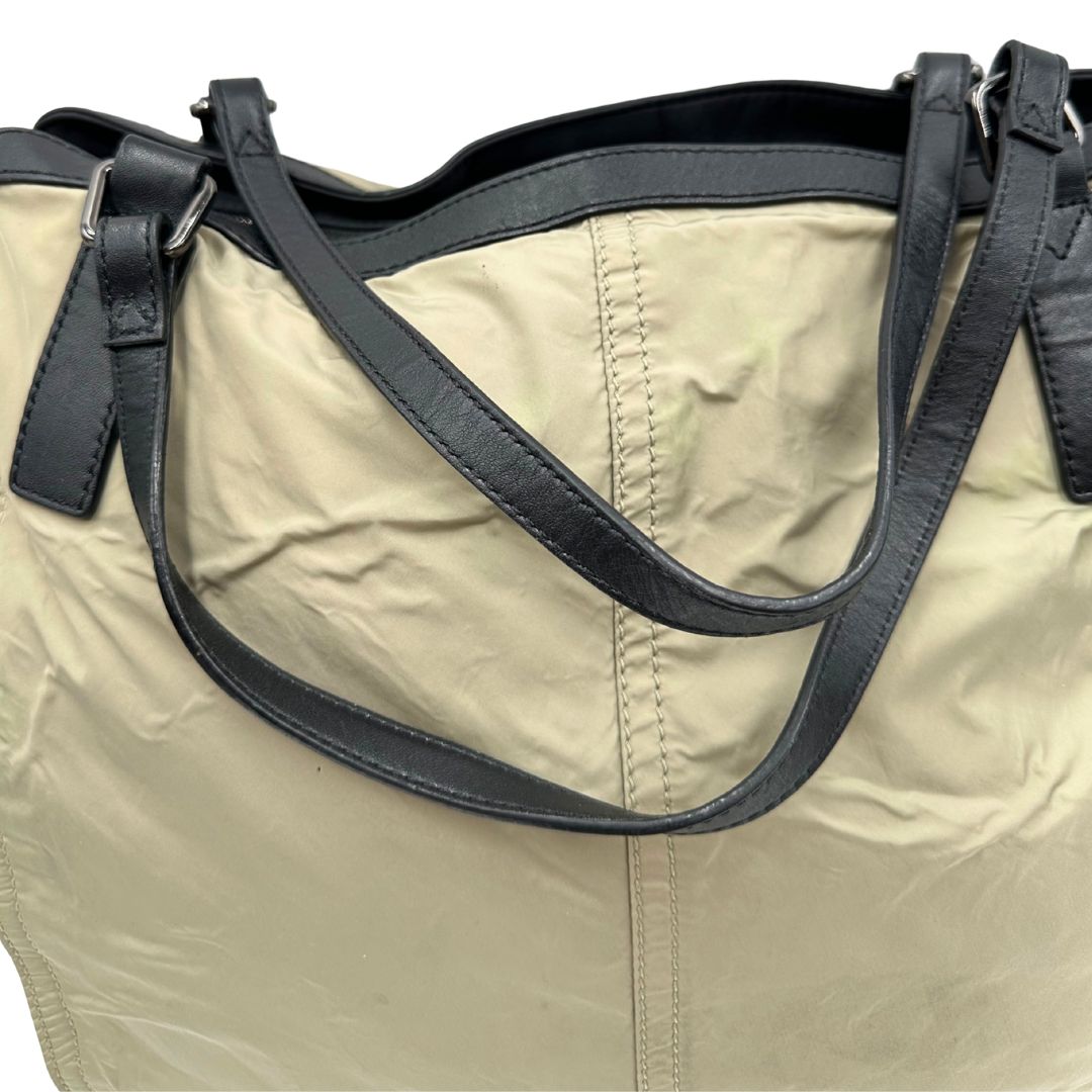 manici Borsa Burberry in nylon color sabbia rifinita con parti in pelle nere e inserti metallici effetto renio; munita di doppi manici, da indossare a spalla 