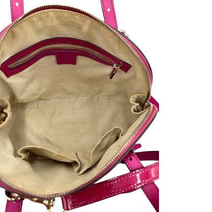 interno Borsa Gucci in pelle verniciata rosso fragola rifinita con inserti metallici oro chiaro; munita di doppi manici e una tracolla regolabile e amovibile 
