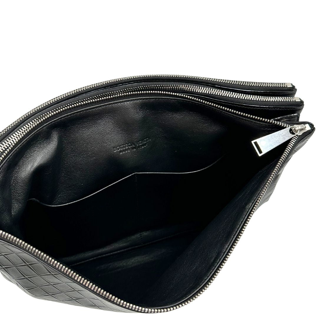 Interno Cartella Bottega Veneta in pelle intrecciata nera, rifinita con inserti metallici argentati e munita di una tracolla regolabile