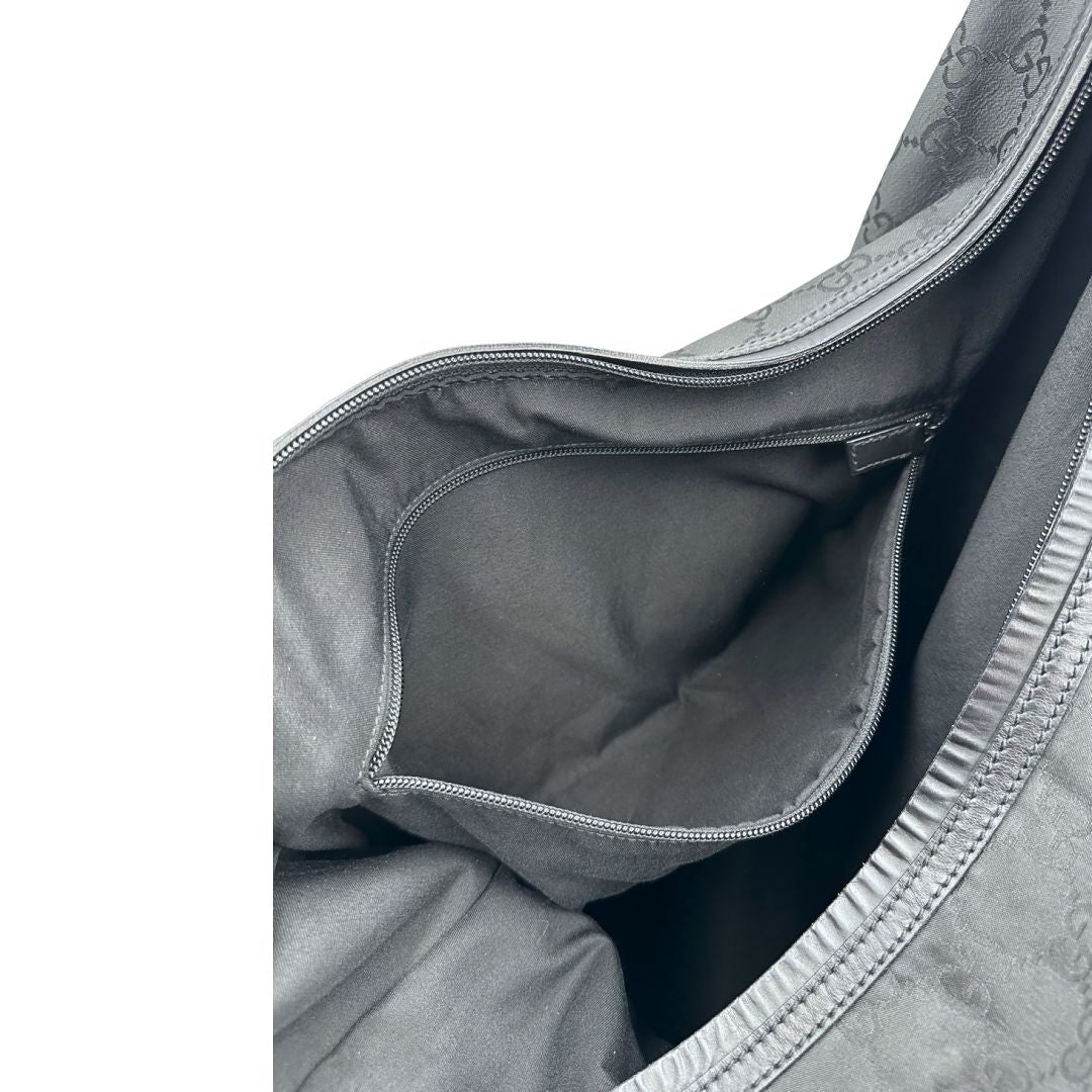 Taschino interno di un borsone Gucci in tessuto trama GG Supreme con parti metalliche argentate e finiture in pelle tono su tono; munita di un manico singolo amovibile. Indossabile a spalla.