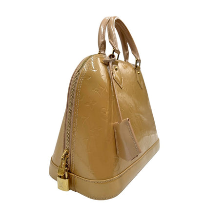 Laterale Alma PM Louis Vuitton in pelle Vernis color noisette con parti metalliche dorate e doppi manici stondati; da portare a mano. Originale, usato, in condizioni ottime. 