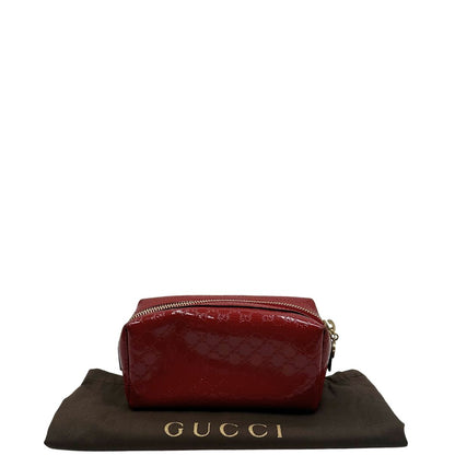 dustbag Pochette in pelle rossa verniciata monogram con parti metalliche dorate. Completa di dustbag, di lusso, originale, ottime condizioni 