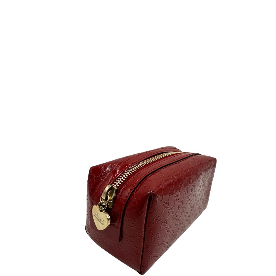 lato Pochette in pelle rossa verniciata monogram con parti metalliche dorate. Completa di dustbag, di lusso, originale, ottime condizioni 