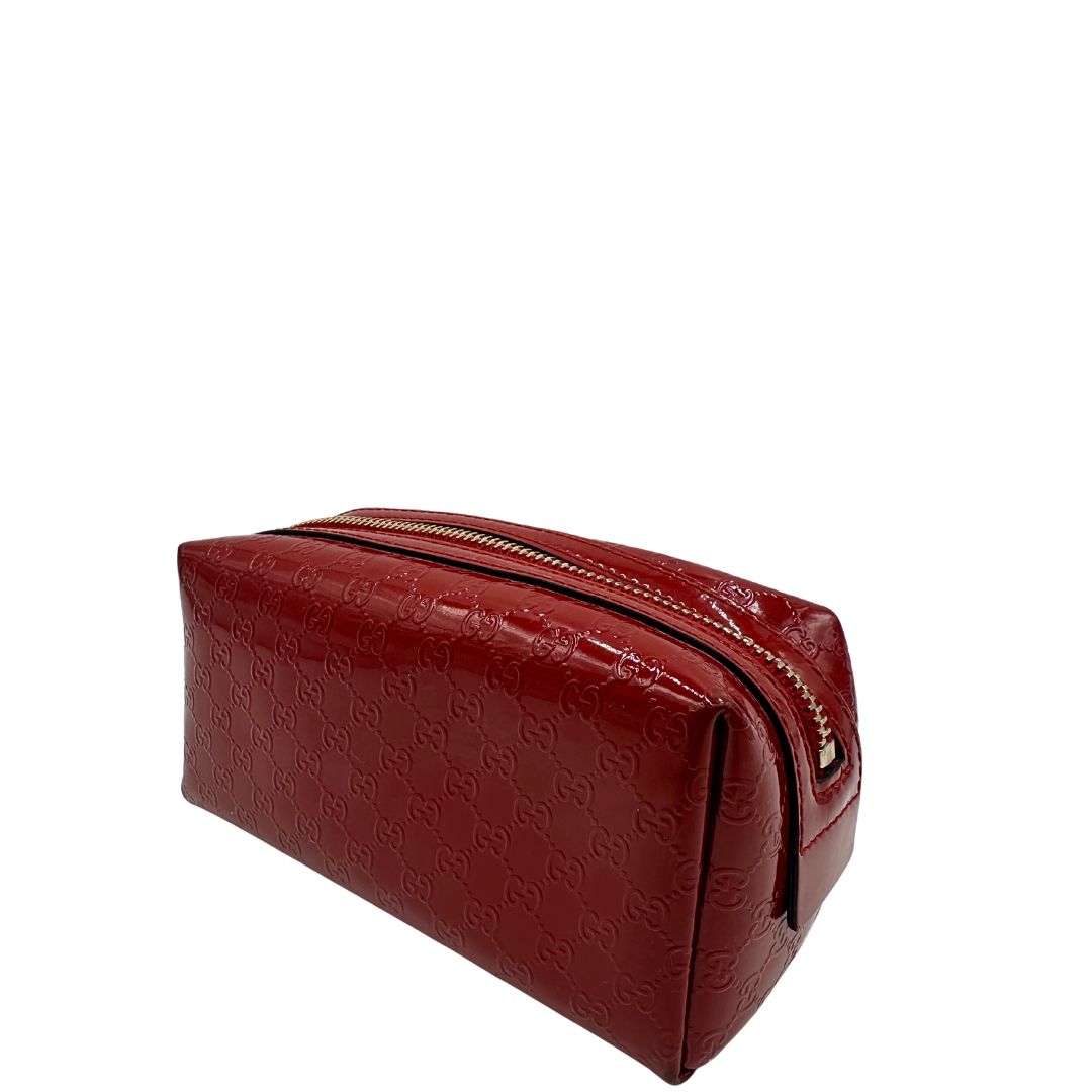 lato Pochette in pelle rossa verniciata monogram con parti metalliche dorate. Completa di dustbag, di lusso, originale, ottime condizioni 