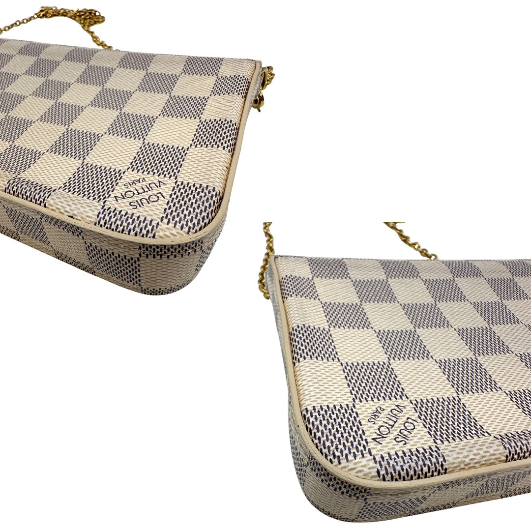 Angoli Borsa Louis Vuitton Félicie in canvas Damier Azur con parti metalliche dorate e interno in pelle rosa. Munita di una tracolla in catena amovibile e accessori portacarte, e portamonete estraibili. Originale, usato, in condizioni ottime.