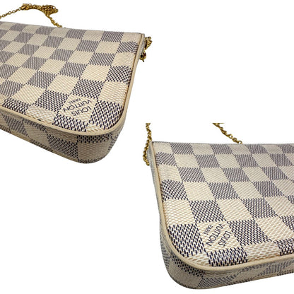 Angoli Borsa Louis Vuitton Félicie in canvas Damier Azur con parti metalliche dorate e interno in pelle rosa. Munita di una tracolla in catena amovibile e accessori portacarte, e portamonete estraibili. Originale, usato, in condizioni ottime.