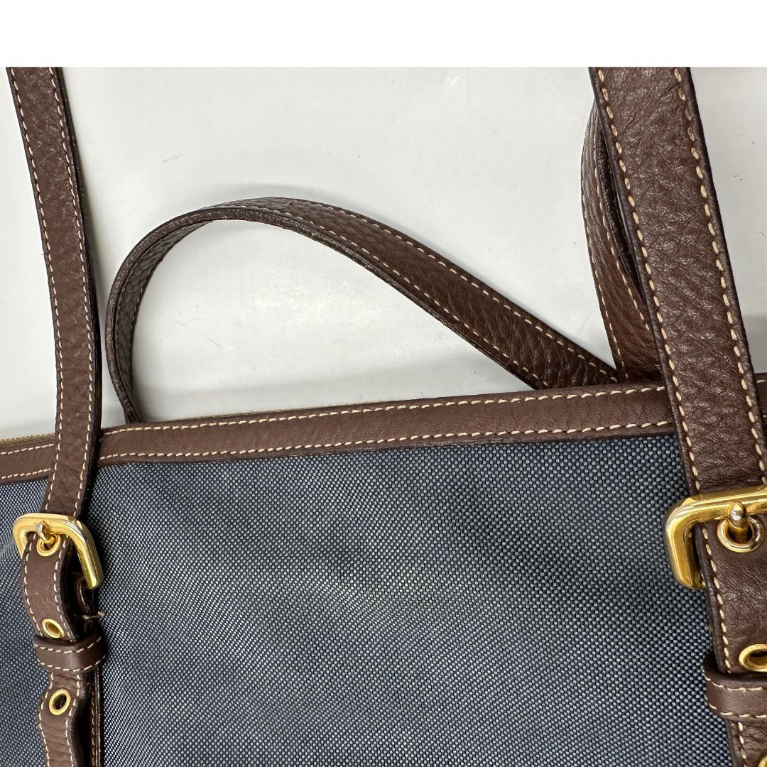 manici Borsa Prada in denim con finiture in pelle marroni e parti metalliche dorate; munita di doppi manici e una tracolla amovibile e regolabile, impreziosita da un porta address. Completa di dustbag, di lusso, ottime condizioni, originale. 