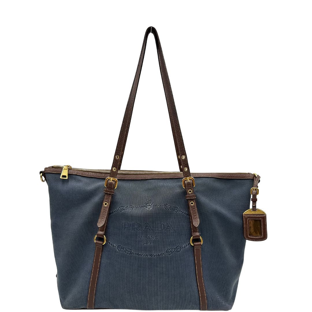 front Borsa Prada in denim con finiture in pelle marroni e parti metalliche dorate; munita di doppi manici e una tracolla amovibile e regolabile, impreziosita da un porta address. Completa di dustbag, di lusso, ottime condizioni, originale. 