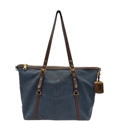 front Borsa Prada in denim con finiture in pelle marroni e parti metalliche dorate; munita di doppi manici e una tracolla amovibile e regolabile, impreziosita da un porta address. Completa di dustbag, di lusso, ottime condizioni, originale. 