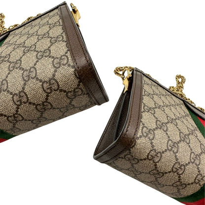angoli Borsa Gucci Ophidia in canvas beige GG con finiture in pelle marrone, striscia Web in tessuto verde e rosso, con parti metalliche dorate. Dotata di una tracolla in catena, di lusso, originale, ottime condizioni. 