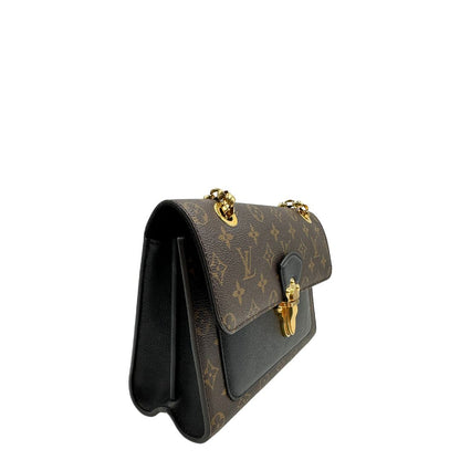 lato Borsa Louis Vuitton Victoire in canvas marrone monogram, finiture in pelle nera e parti metalliche dorate; munita di una tracolla in catena scorrevole. Completa di scatola, di lusso, originale. 