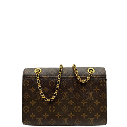 retro Borsa in canvas marrone monogram, finiture nere e parti metalliche dorate; munita di una tracolla in catena scorrevole. Completa di scatola, di lusso, originale, ottime condizioni.