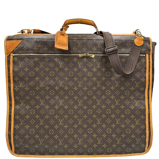 front Borsa da viaggio in canvas marrone monogram con finiture in vacchetta naturale e parti metalliche dorate; munita di un manico singolo,una tracolla amovibile e regolabile e 5 grucce, di lusso, originale, ottime condizioni.