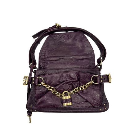 Borsa Chloé Maxi Lock in pelle viola prugna con parti metalliche dorate. Munita di un manico regolabile e impreziosita da una catena sul front con lucchetto. Originale, usato, in condizioni ottime. 
