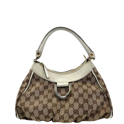 Borsa Gucci Hobo D-Ring in tessuto beige GG con finiture in pelle bianca e parti metalliche dorate. Munita di un manico in pelle stondato, rifinita con dettaglio D-Ring e logo lettering sul front. Completa di dustbag. Originale, usato, in condizioni ottime. 