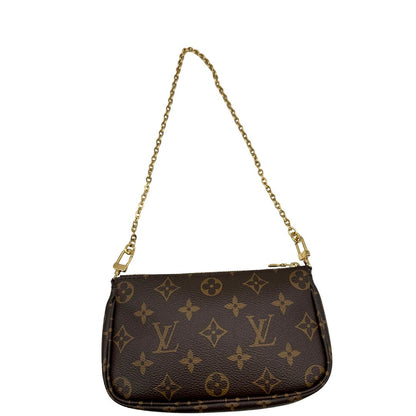 Mini Pochette di una Multi Pochette Accessoires Louis Vuitton in canvas marrone monogram con dettagli in vacchetta naturale, manico in catena dorata e tracolla in tessuto Jacquard verde kaki. Dotata del classico mini portamonete rotondo, rimovibile. Completa di corredo.