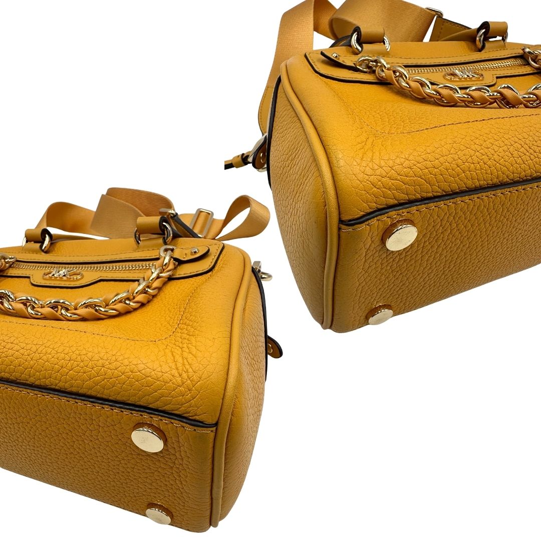 Angoli di una borsa Michael Kors in pelle martellata giallo girasole, con metalleria dorata. Munita di tracolla in tessuto regolabile ed amovibile. Completa di dustbag e cartellini.