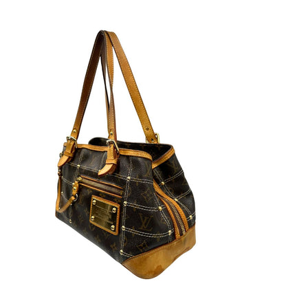 Lato sinistro di una Borsa Louis Vuitton in canvas marrone monogram con cuciture decorative e finiture in vacchetta naturale. Parti metalliche dorate; munita di doppi manici, indossabile a spalla. Originale, usata, di lusso in ottime condizioni