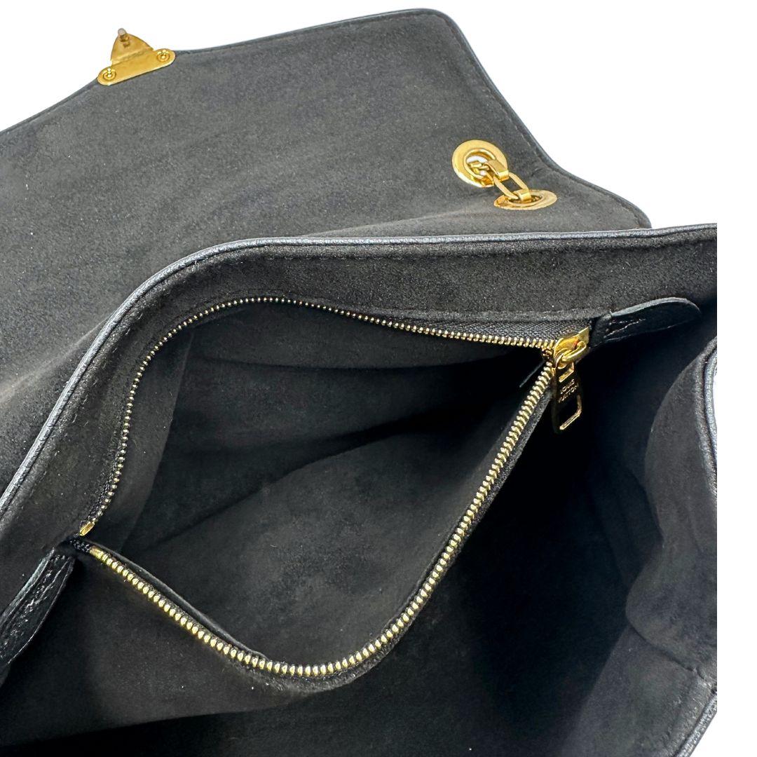 Interno di una borsa Louis Vuitton in pelle nera monogram Empreinte con parti metalliche dorate; munita di una tracolla scorrevole in catena. Indossabile a spalla e a tracolla.