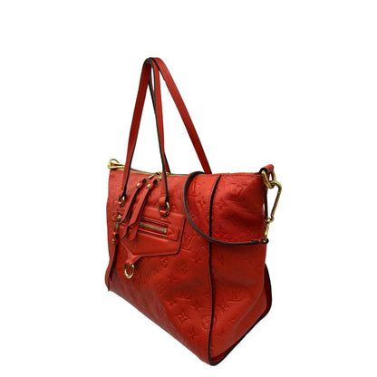 lato Borsa Louis Vuitton pelle color rosso aranciato monogram Empreinte con parti metalliche dorate; munita di doppi manici e una tracolla amovibile e regolabile. Completa di lucchetto e chiavi, di lusso, originale, ottime condizioni. 