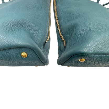 angoli Borsa Tote Prada in pelle martellata color teal con parti metalliche dorate; munita di doppi manici, indossabile a spalla. Completa di dustbag, di lusso, originale, usata. 