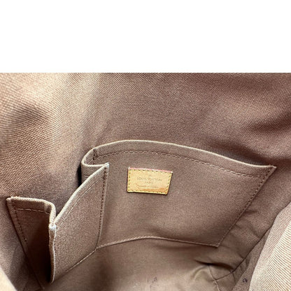 interno Borsa Odeon PM Louis Vuitton in canvas marrone monogram con finiture in vacchetta naturale e parti metalliche dorate. Dotata di tracolla regolabile con fibbia, di lusso, originale, buone condizioni, usata. 